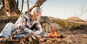 Campfire hiking woman with backpack cook countryside